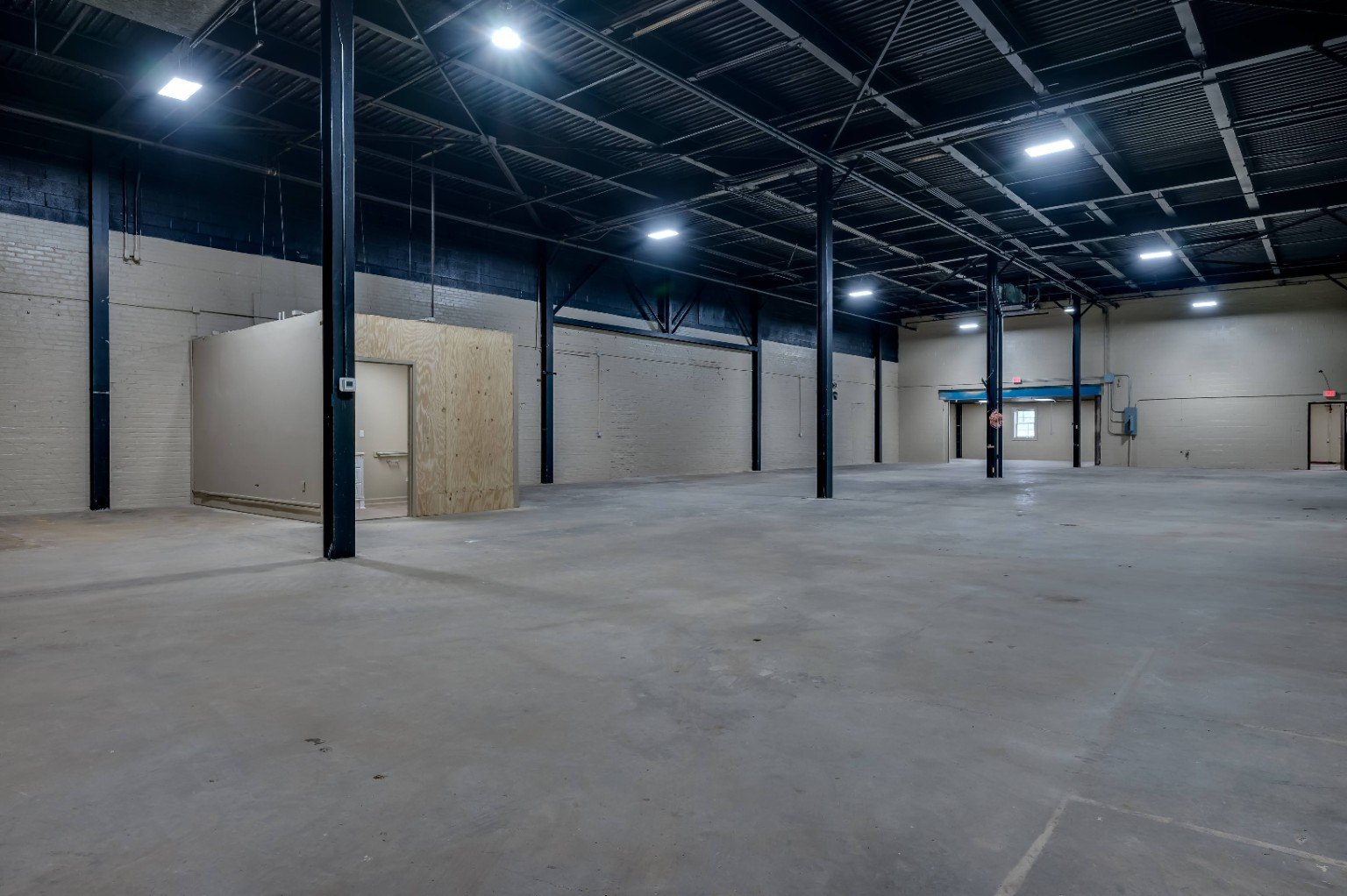Area Three clean industrial interior with black steel columns